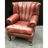 A Tetrad Blake ox blood leather armchair, scrolling, padded arms, squab cushion, cabriole forelegs,