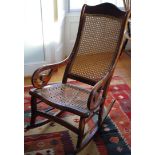A 19th century rocker chair, bergere back and seat, scroll arms, c.1870
