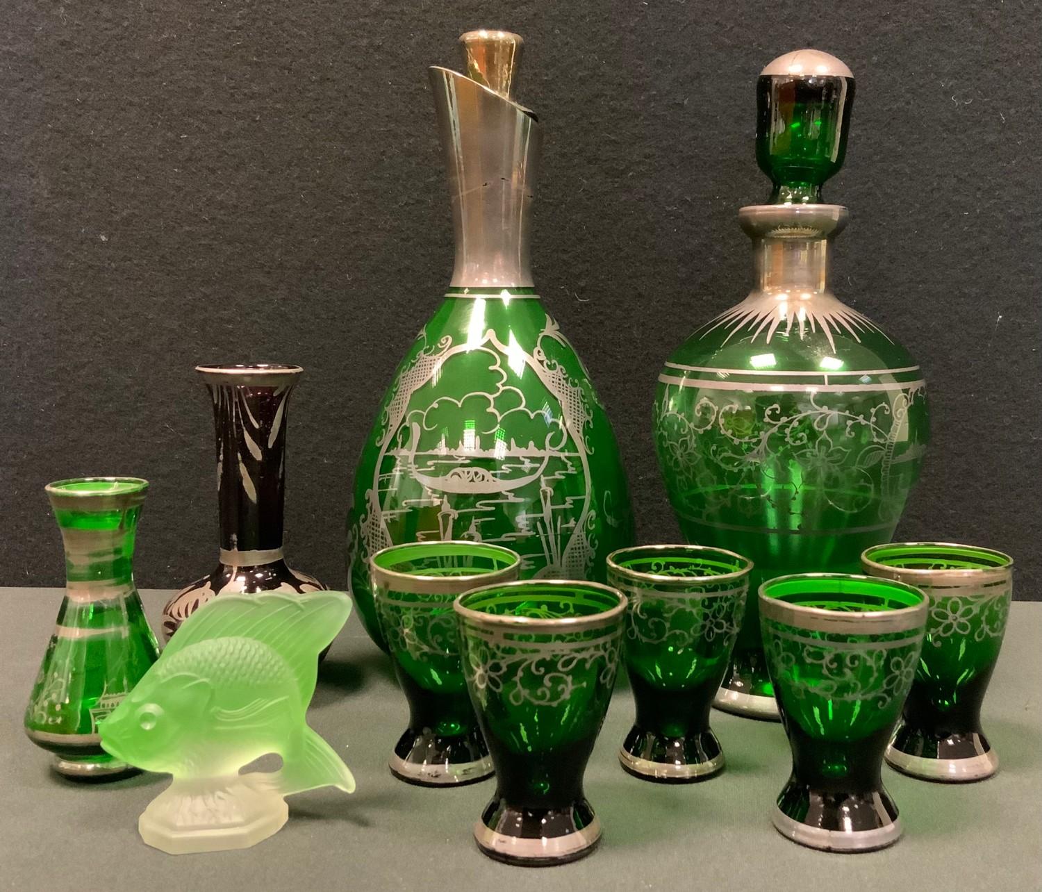 Glass - a late 19th century Venetian green glass six piece liqueur drinking set, decanter and five