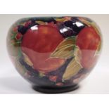 A Moorcroft pottery Pomegranate and fruit pattern compressed ovoid vase, tubelined with a continuous