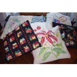 A tapestry cushion, embroidered with an orchid, on a cream ground; others, various (8)