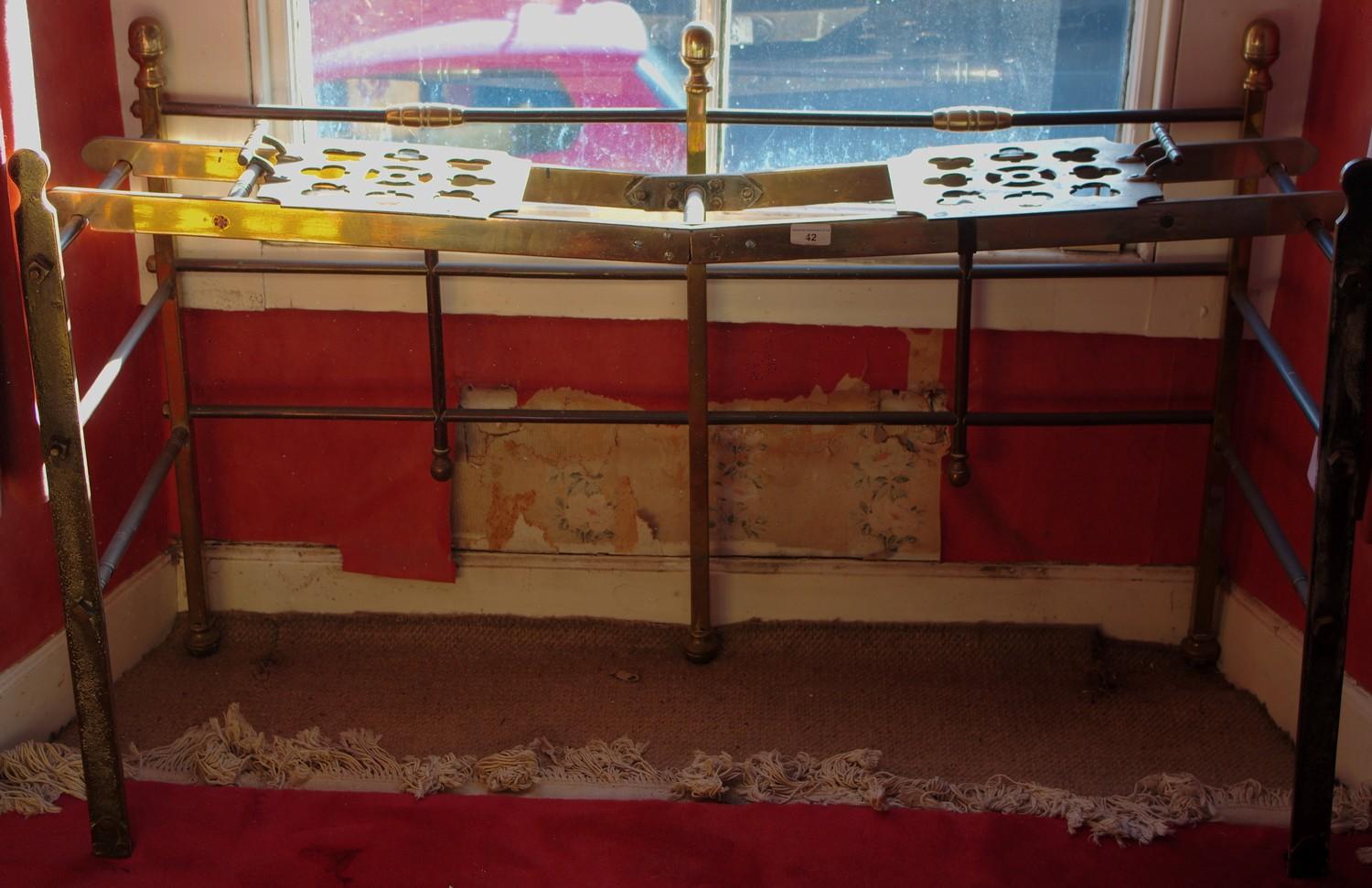 A 19th century folding brass and iron hearth rack, with brass sliding pierced plates, 76cm high,