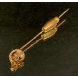 An Edwardian opal and moonstone inset tie pin, yellow metal spiralled pin body, stamped 15ct, 57mm