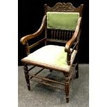 A 19th century American carved oak arm chair, shaped top rail, turned gallery, scrolling arms,