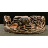 A novelty white metal bottle stand as a herd of elephants playing, impressed mark, 13cm wide