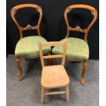 A pair of Victorian walnut carved back side chairs, floral upholstered seats, cabriole legs; a