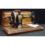 A Vintage Jones CS hand operated portable sewing Machine, I curved walnut case, c.1910