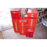 Six red metal filing cabinets, various sizes, the largest 70cm x 28cm x 41cm