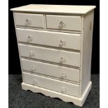 A painted pine chest of two short drawers over four long, shaped apron. 108cm high x 96.5cm wide x