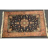 A Persian garden design rug, central floral medallion within sinuous flowering vines, deep blue