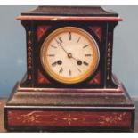 A Victorian slate mantel clock, rouge marble, roman numerals, twin winding holes, striking on a