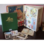 A mid 20th century scrap album; postcards; School Boy stamp album;