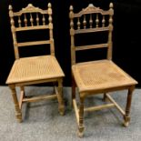 A pair of Edwardian oak salon chairs, wicker seats, turned supports, H-stretcher, c.1910