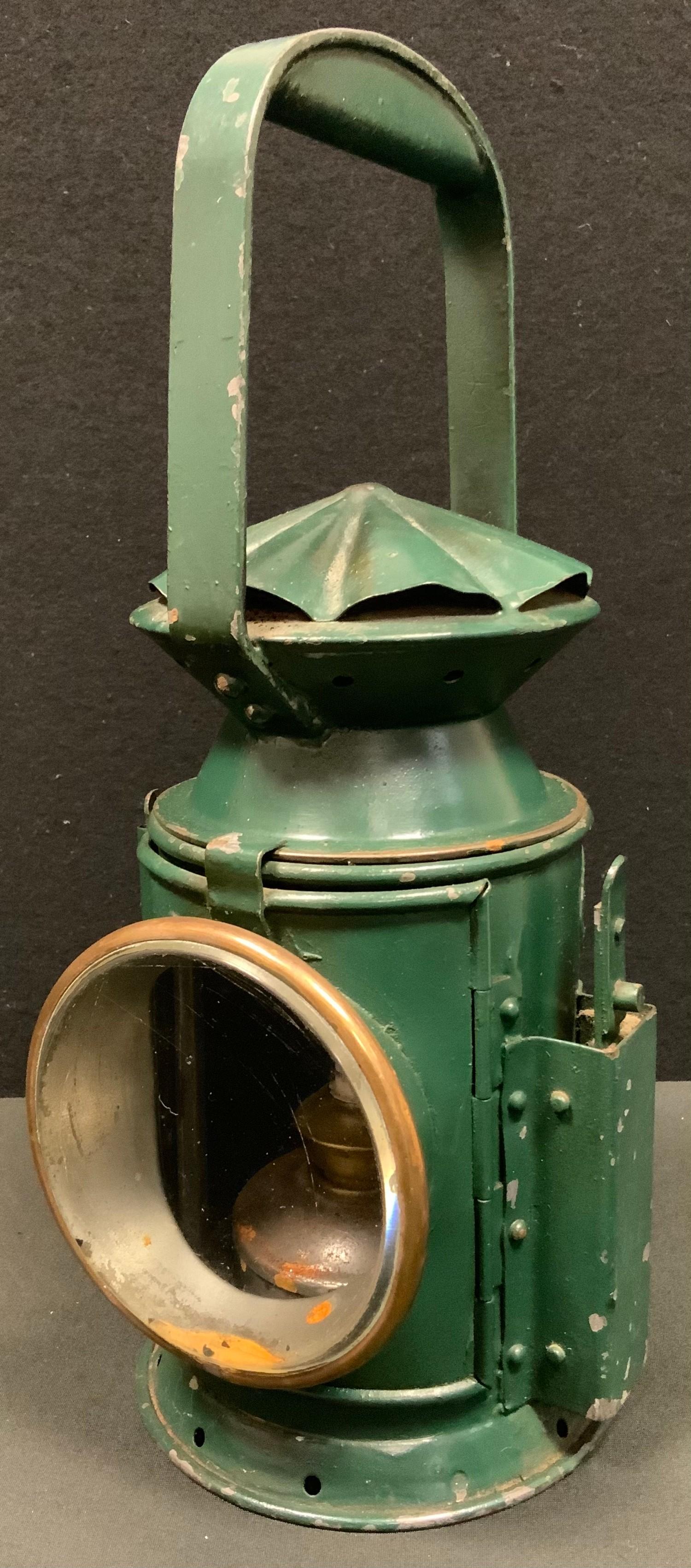 A World War II period green painted military issue Railway guardsman's lamp, by C Eastgate & Sons,