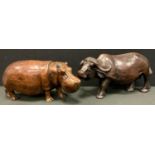 A carved fruit wood model of a Hippopotamus, another Water Buffalo, both signed Denis, largest