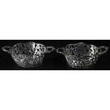 A pair of Dutch silver shaped oval sweetmeat baskets, pierced and chased with flowers and