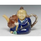A English majolica Chinaman teapot, modelled as a portly seated Oriental, grasping a mask from which