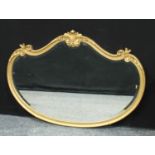 A 20th century shaped oval gilt framed looking glass, 79cm high, 111cm wide.