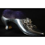 A Victorian silver novelty pin cushion, as a ribbon-tied shoe, 11cm long, Birmingham 1890