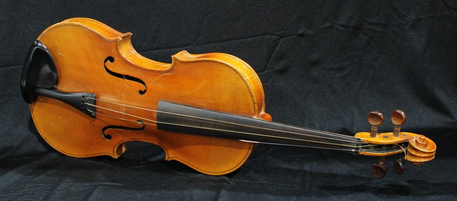 A violin, the two-piece back 35.5cm long excluding button, outlined throughout with purfling, 61cm