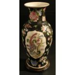 A large Chinese Famille Noir vase, decorated with Dragon and Phoenix, hardwood stand