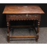 A 17th century oak side table, oversailing rectangular top above one long carved drawer, shaped