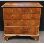A George II walnut chest of drawers, oversailing rectangular top above two short and three long