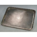 A silver rounded rectangular dressing table tray, engine turned, monogrammed, Birmingham 1938,