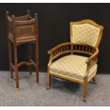 An Edwardian rosewood drawing room club arm-chair, shaped back, stuffed over upholstery, tapered