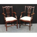 A pair of Chippendale Revival mahogany armchairs, carved in relief, serpentine front rails, early