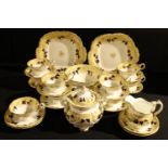 A 19th century Rockingham type tea set printed and painted with leafy scrolls in blue and ocher on a