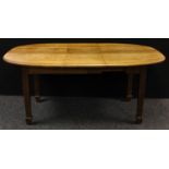 An Arts and Crafts oak extending dining table, oval top, tapered square legs, spade feet,