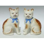 A pair of Staffordshire pottery cats, approx. 21cm high