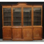 A regency design brake centre library bookcase, arched outswept cornice above four glazed doors