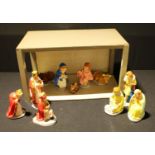 A mid 20th century Nativity scene comprising eleven painted plaster figures and scratch built stable