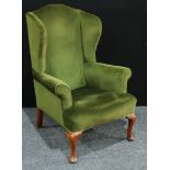 A George II style wing back arm chair, scroll arms, cabriole legs, pad feet, 119cm high.