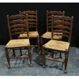 A set of four 20th century oak ladder back rush seat kitchen chairs.(4)