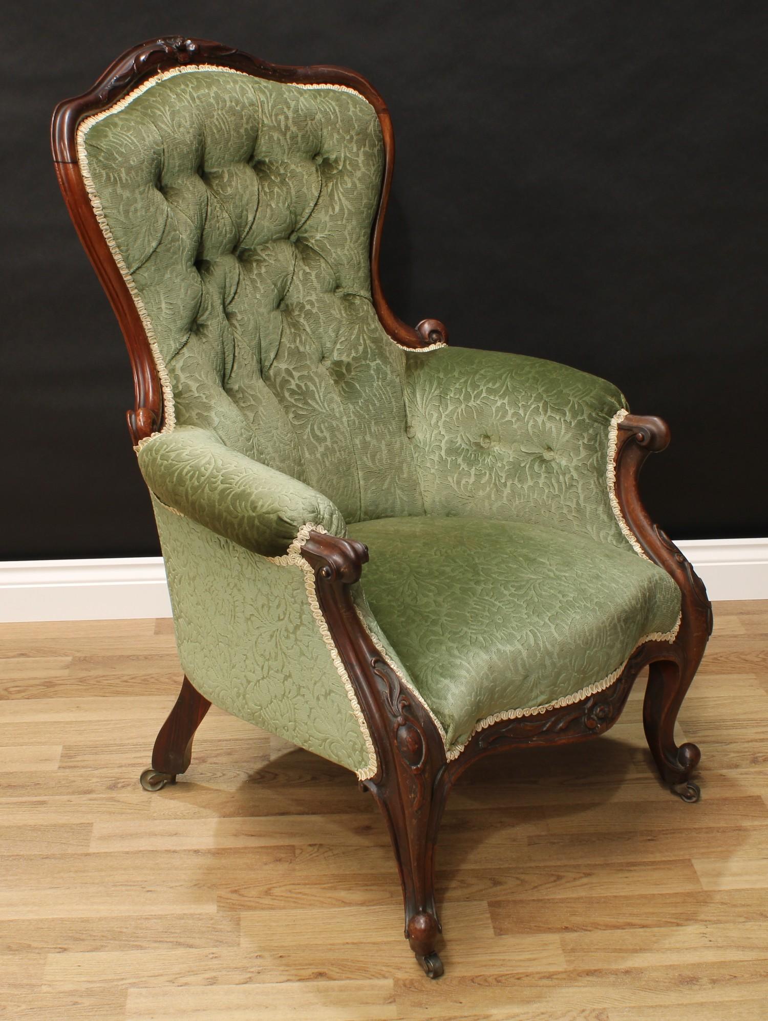 A Victorian rosewood drawing room chair, shaped back with carved serpentine cresting, scroll arms,