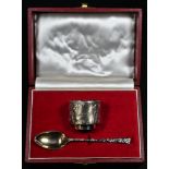 A Modern silver egg cup and spoon heavily cast with bark texture, the cup 3.5cm high, Cooper