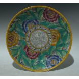 A Crown Ducal Charlotte Rhead circular plate, tube lined with large flowerheads in pink, yellow