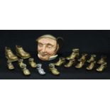 Royal Doulton James John character jug; a collection of brass shoes, various sizes