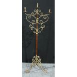 A wrought iron floor standing three branch candelabra, 165.5cm high.