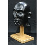 A fibre glass bust, wooden stand, 39cm high