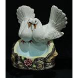 A large Capo-di-Monte model of love birds above a blue pool, 39cm high