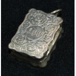 A Victorian shaped rectangular silver vinaigrette, the hinged cover enclosing a gilt interior with