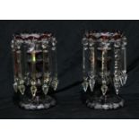 A pair of Bohemian ruby glass lustres, engraved with grapes, vine and leaping deer