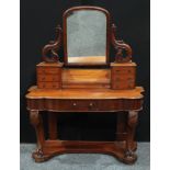 A Victorian mahogany dressing table, arched rectangular mirror flanked by scrolling supports pierced