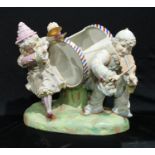 A 19th century style bisque table centre, musicians, he plays the violin, she the cymbals, 29.5cm