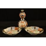 A 19th century Meiji double gourd vase; a pair of shaped oval Imari dishes (3)