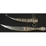 A Middle Eastern silver coloured metal and niello jambiya, 17cm curved blade, the hilt and